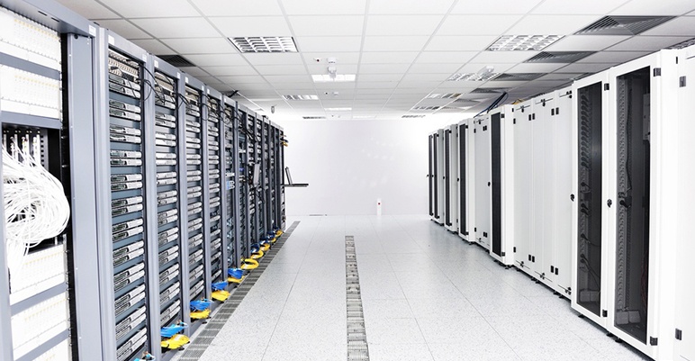Image of data center with servers and air units in the ceiling.