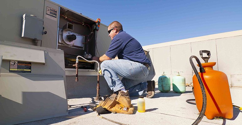 HVAC technician performing HVAC maintenance 